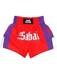 Red embroidered flaming Oni Thai shorts by Sabai Fightwear with intricate flame and Oni designs, showcasing traditional martial arts apparel.
